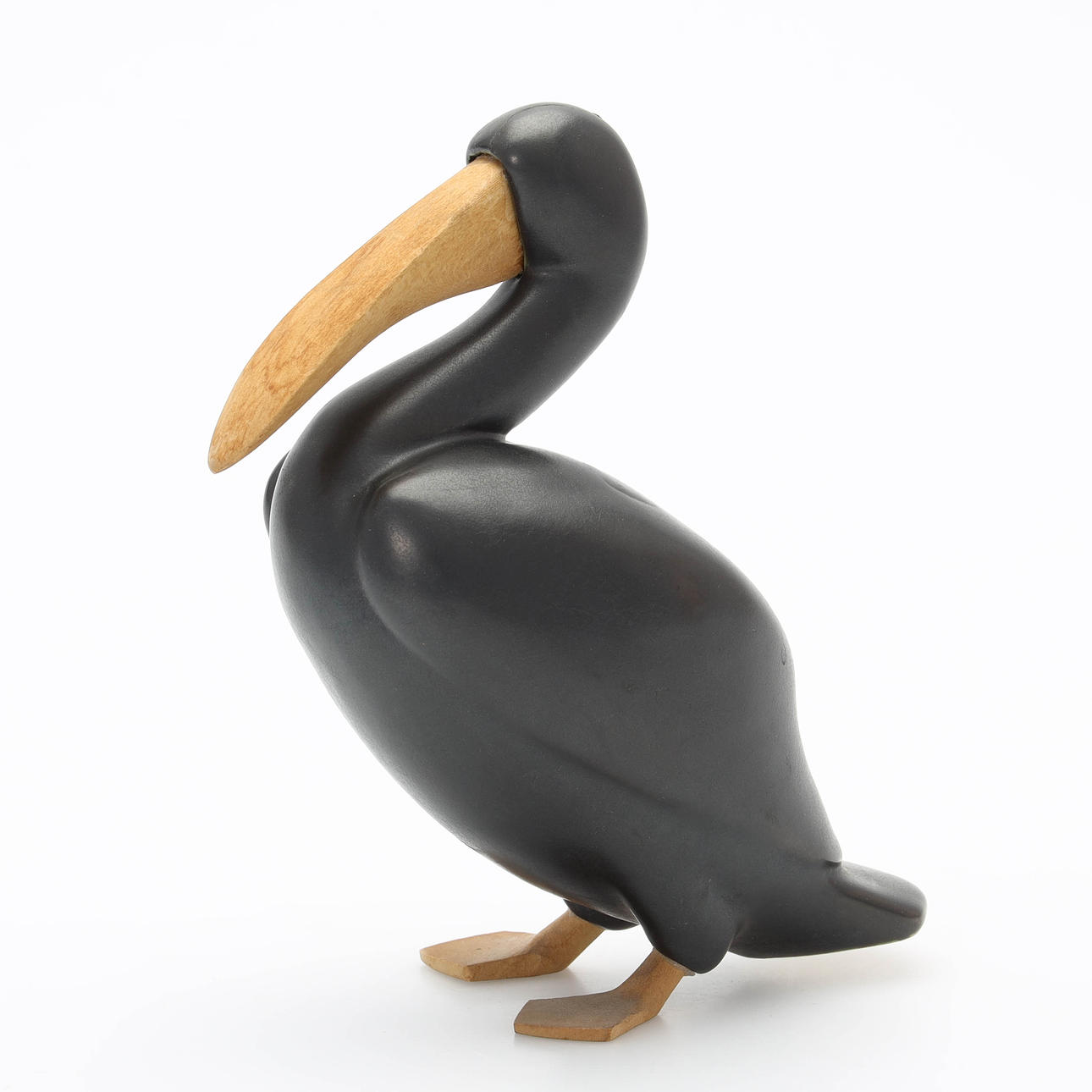 A CERAMIC & WOOD FIGURINE, Pelikan.
