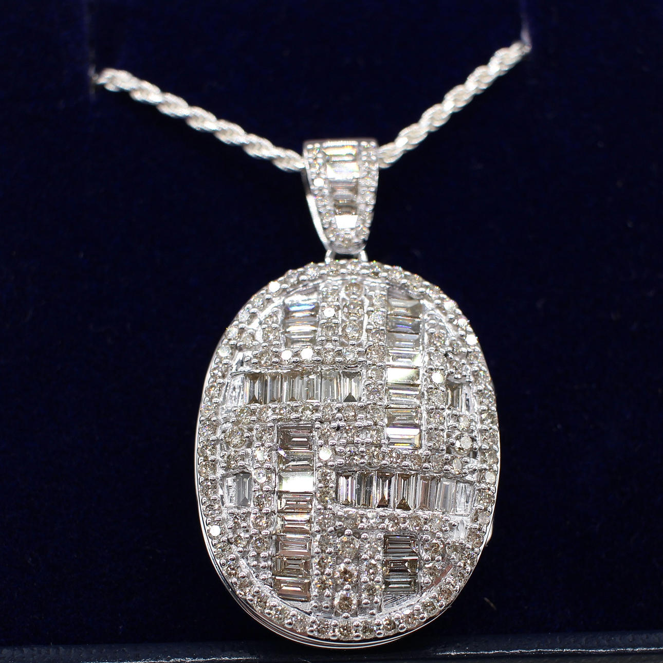 DIAMOND ENCRUSTED WHITE GOLD LOCKET.