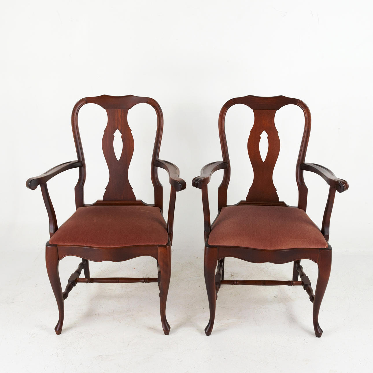A pair of rococo style armchairs, red stained beech, rose red velvet ...