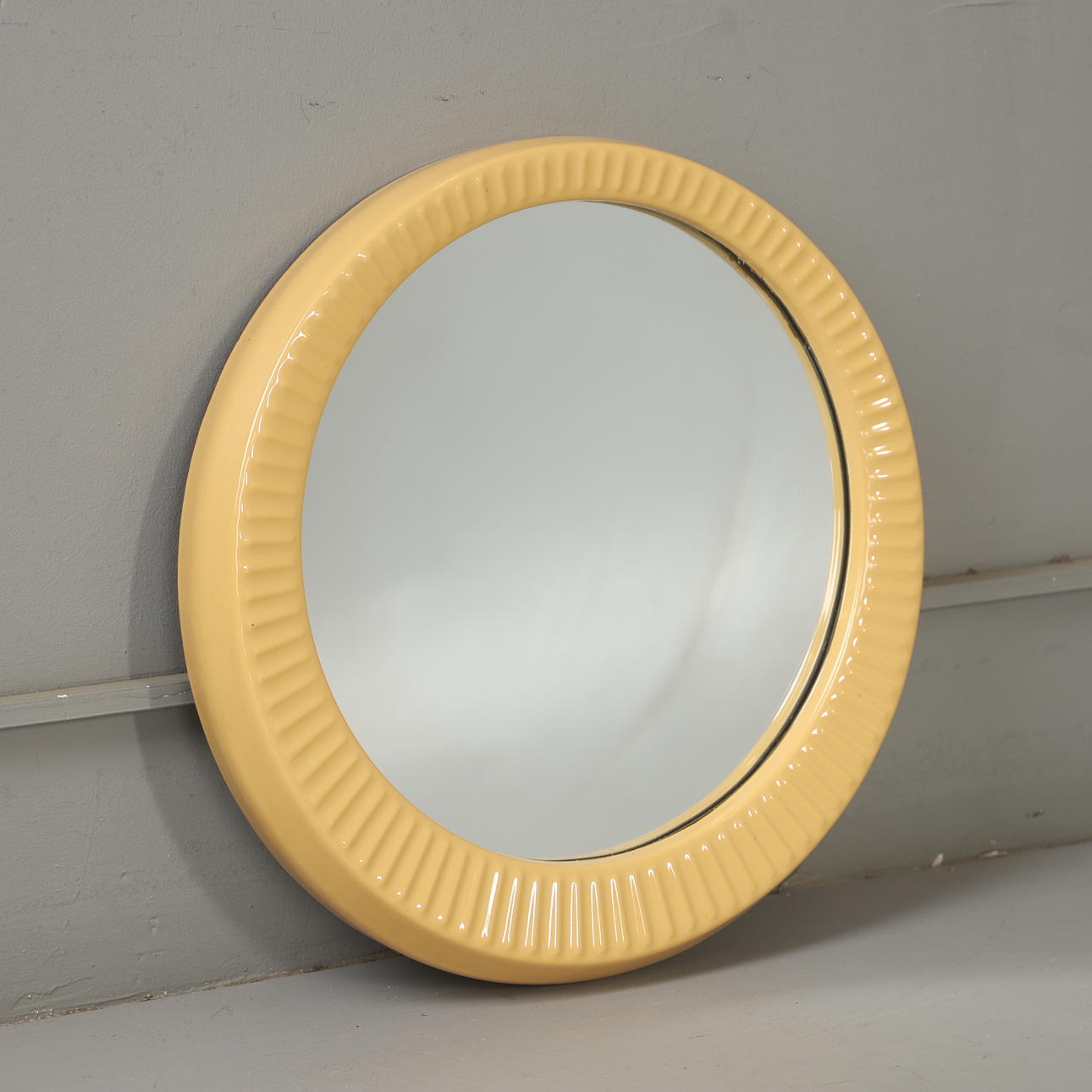 A ceramic frame mirror, mid 20th century.