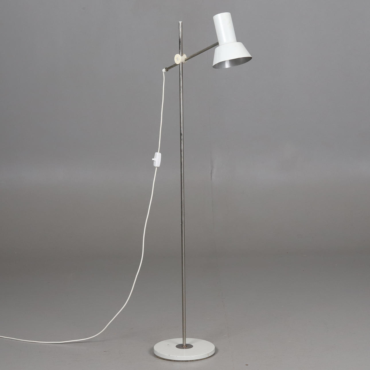 FLOOR LAMP. Chromed frame with white cup. Adjustable height and angle, second half of the 20th century.