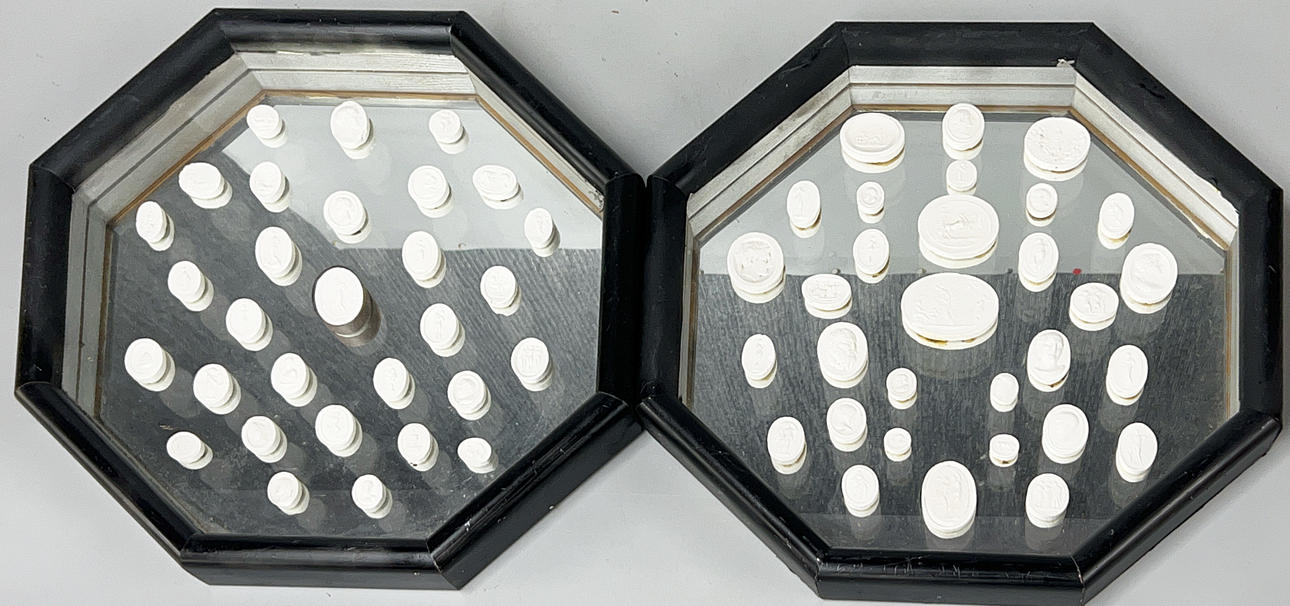 A PAIR OF CASED PLASTER INTAGLIOS.