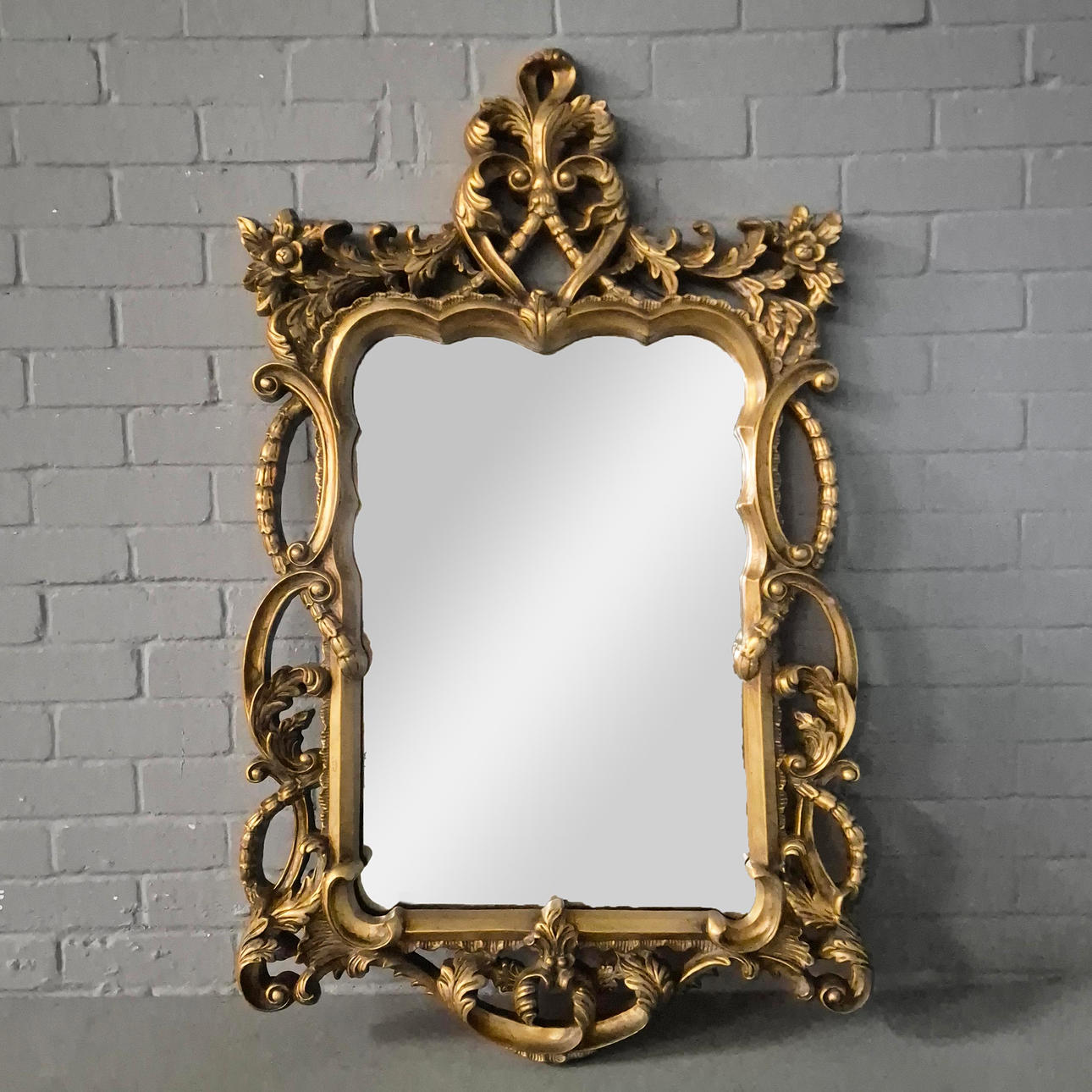A BAROQUE STYLE RECTANGULAR WALL MIRROR.