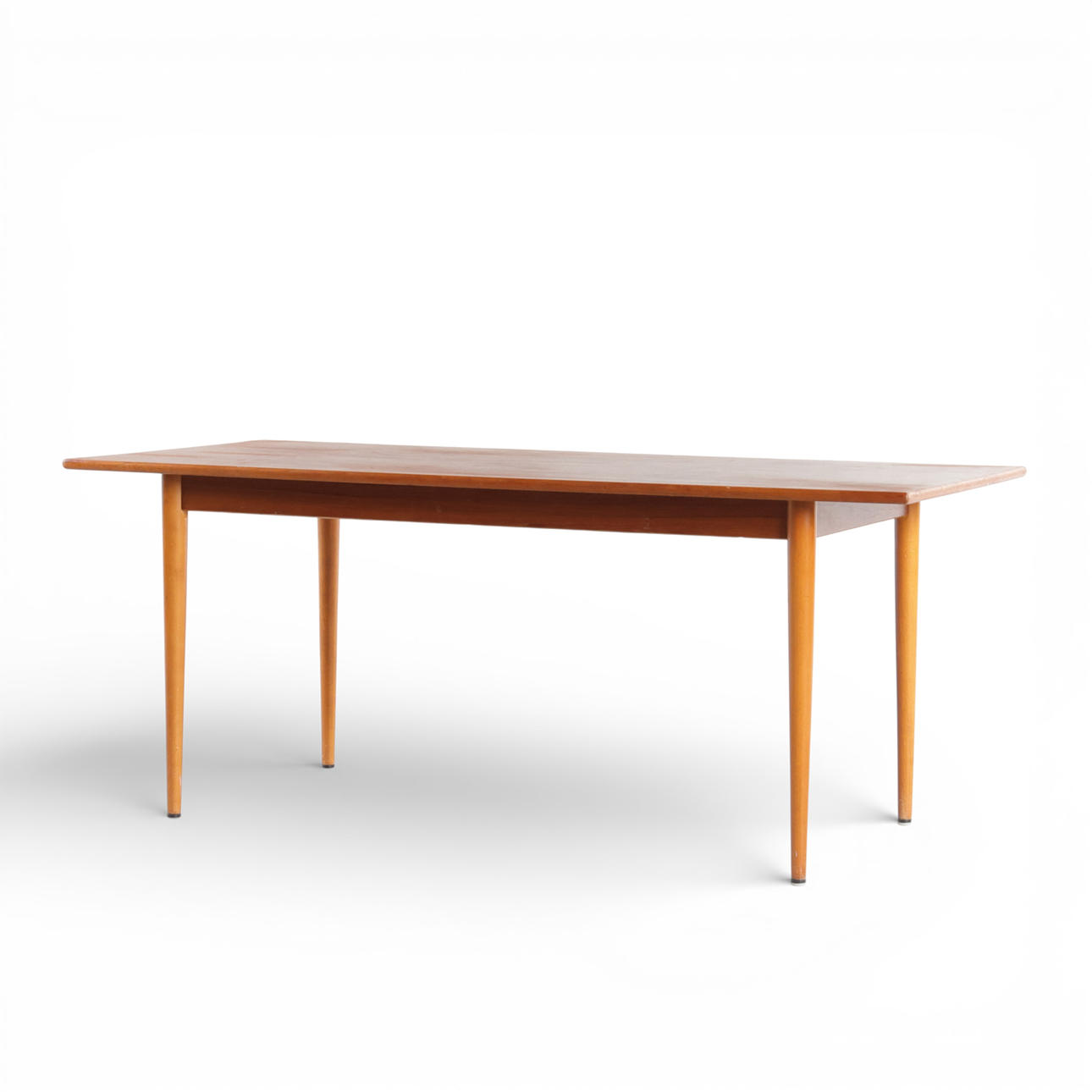Rectangular teak coffee table, round tapered legs of beech. Denmark, 1950s.
