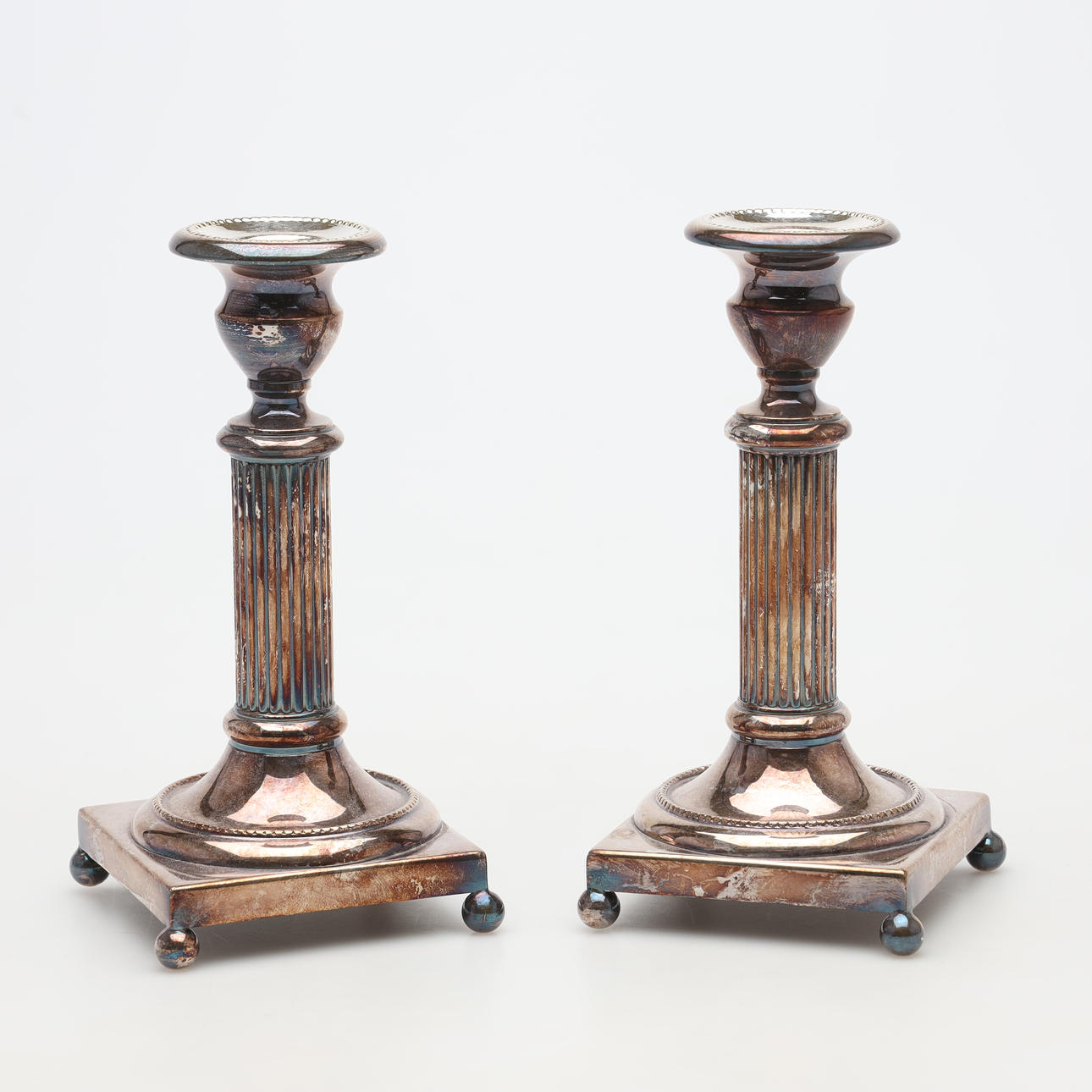 A pair of metal candlesticks.