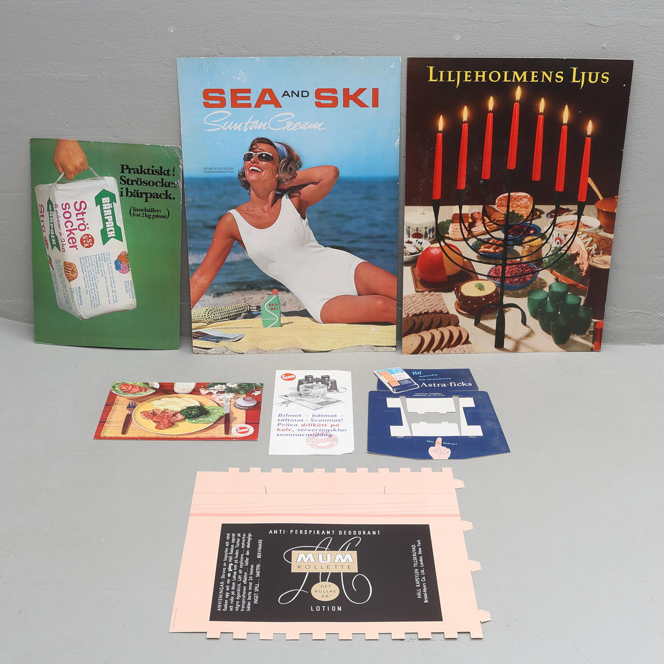 A set of 7 cardboard advertising signs, 20th century.