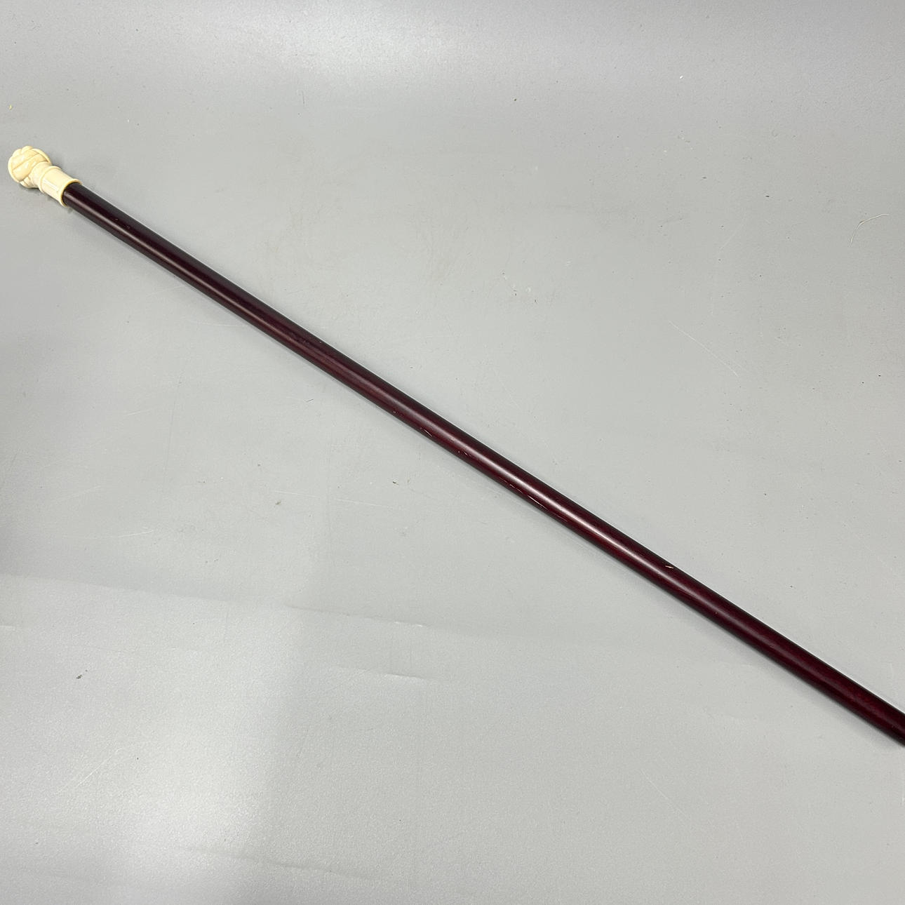 A CARVED BONE TOPPED WALKING STICK.