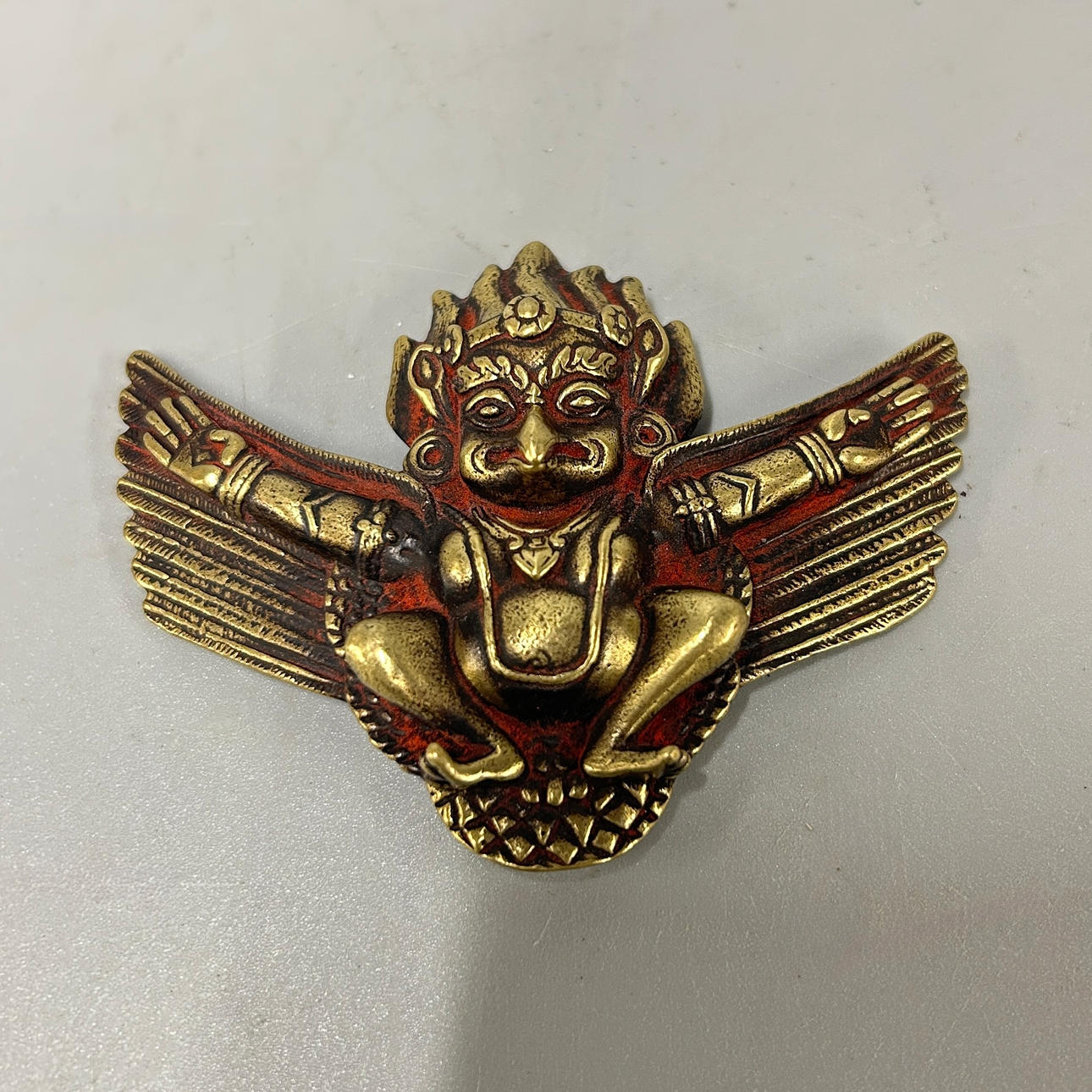 A BRONZE TIBETAN PENDANT.