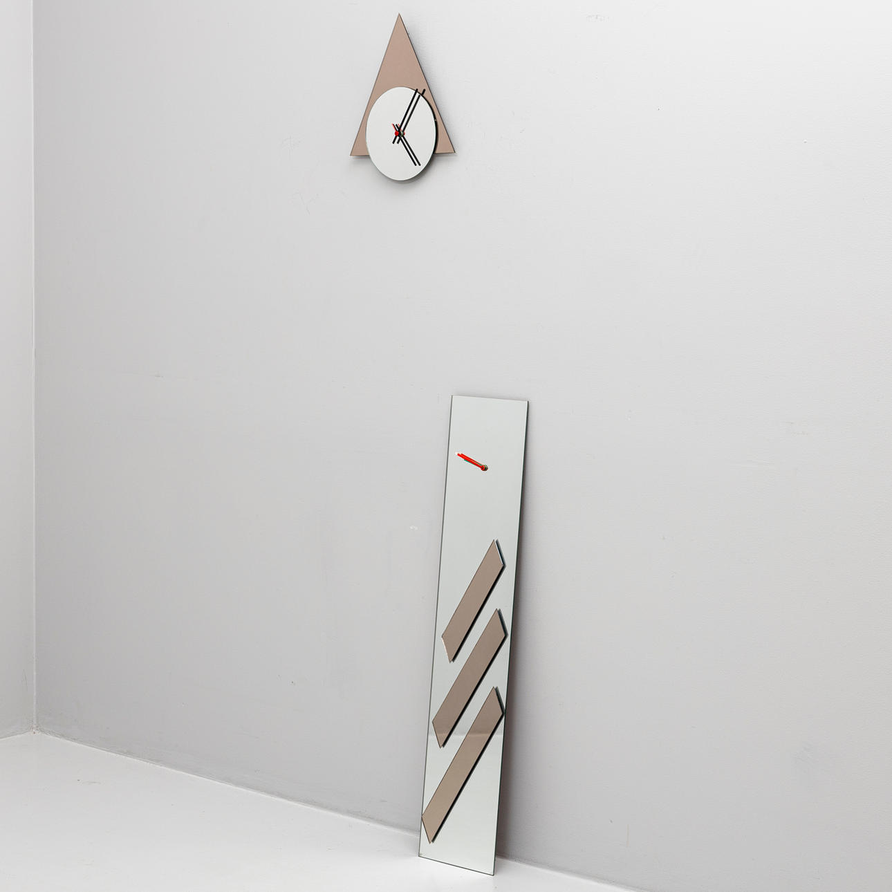 A set of two wall clocks, partly smoke-coloured mirrored glass, 1980s ...