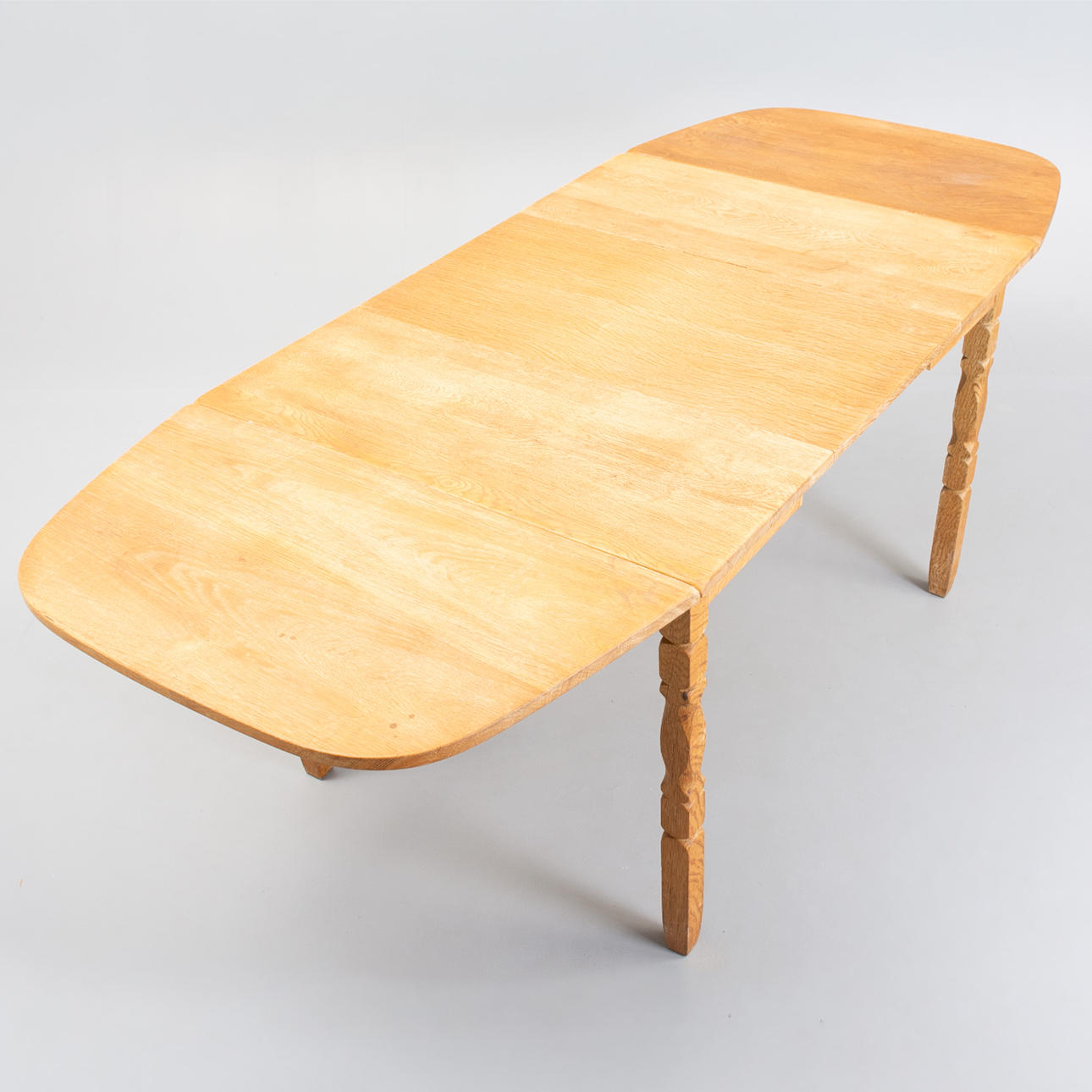 DINING TABLE in oak by Nyrup Møbelfabrik with three additional plates. Denmark, 1970s.