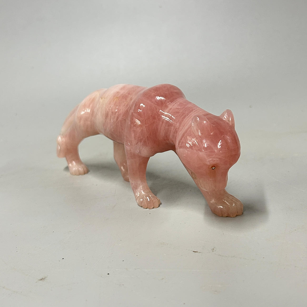 ROSE QUARTZ TIGER WITH DIAMOND SET EYES.