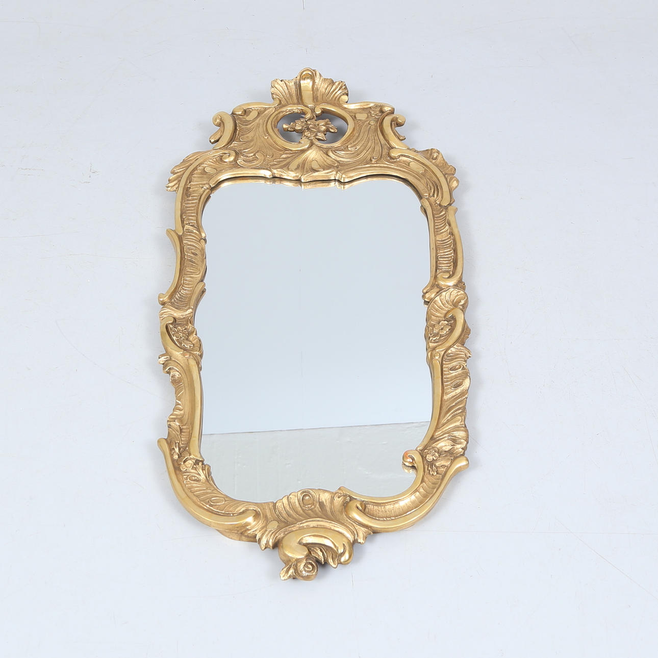 A 20th century rococo style mirror.