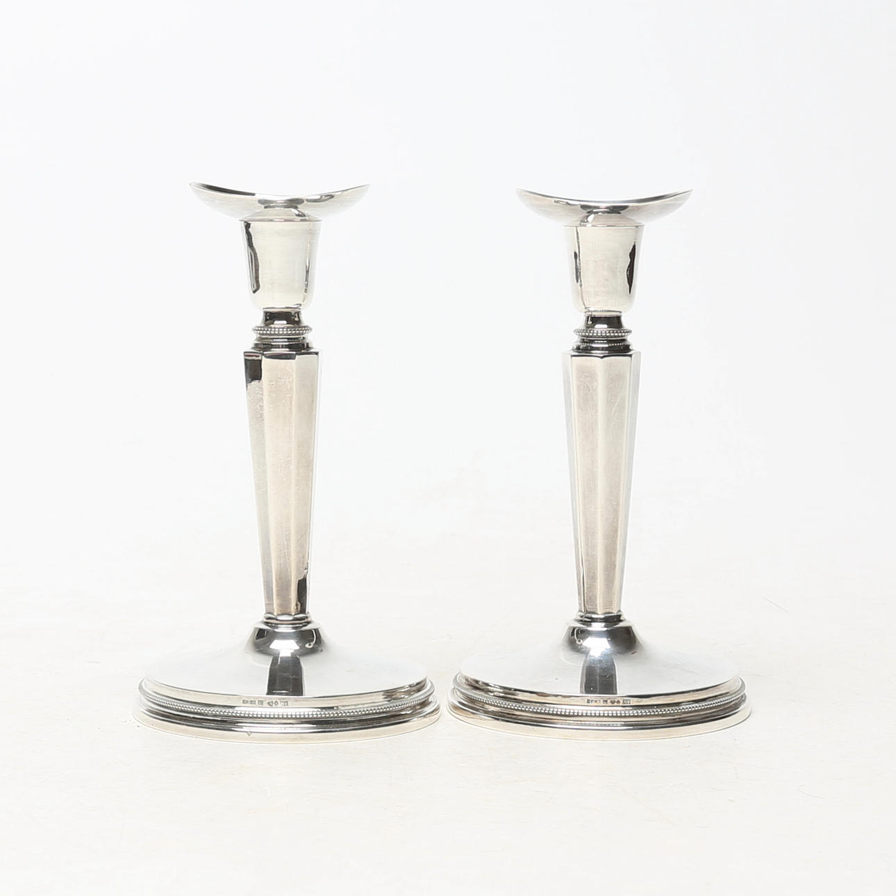 A pair of silver candlesticks.