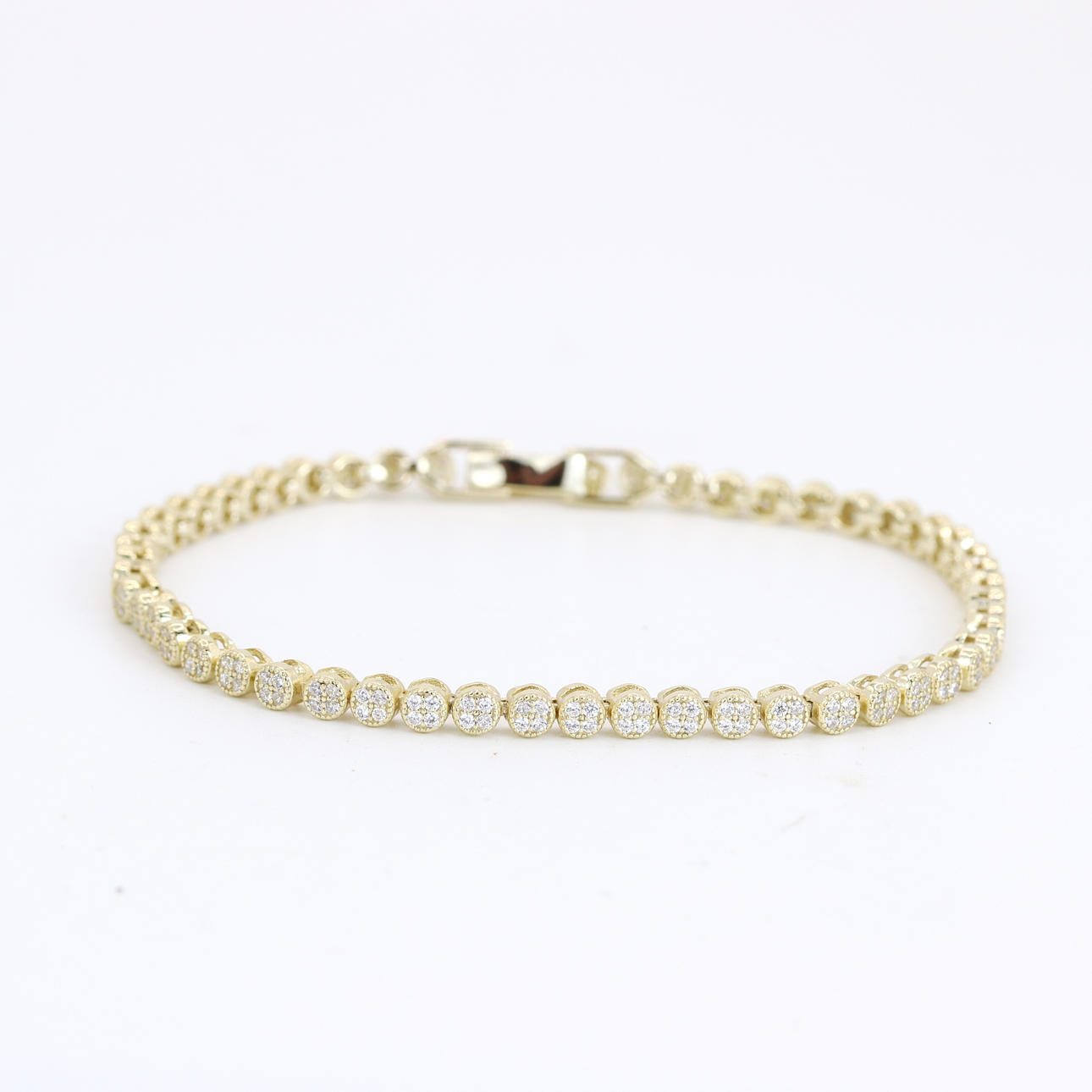 SILVER GILT TENNIS BRACELET.