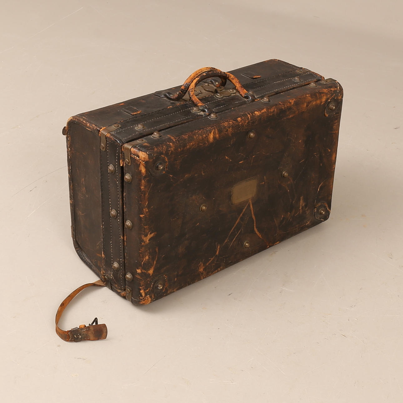 A leather suitcase, early 20th century.