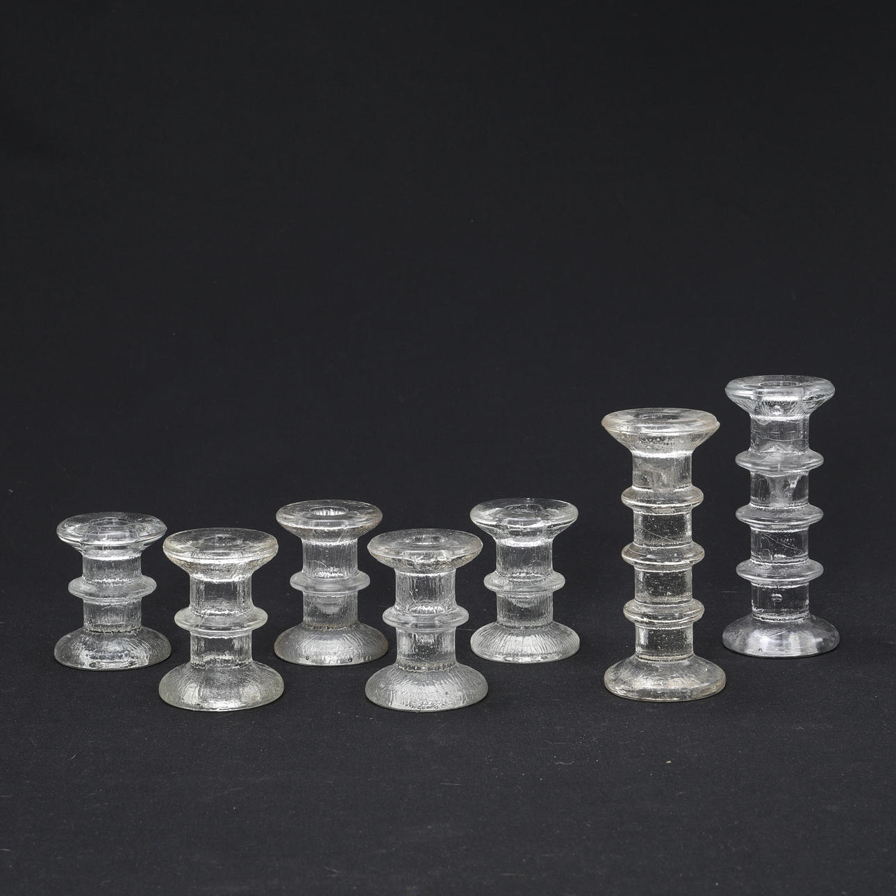 CANDLESTICKS, glass, 7 pieces.