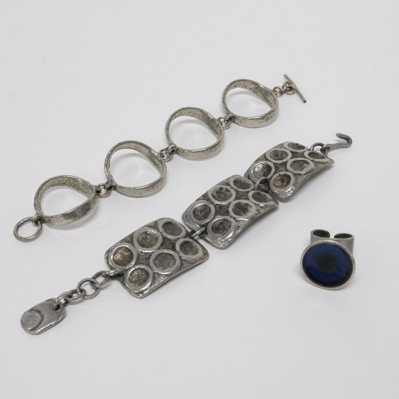 TWO BRACELETS AND A RING, PEWTER.