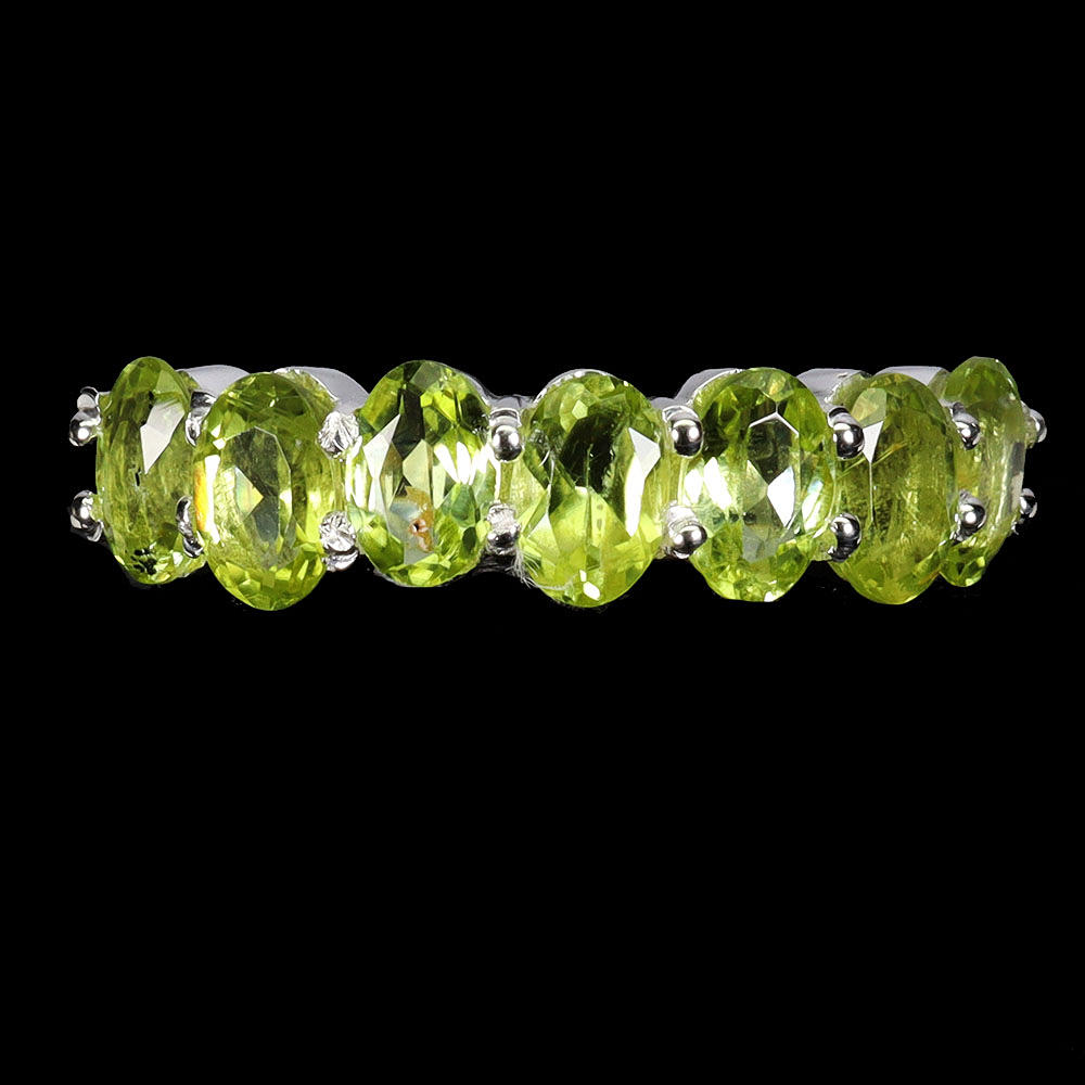 PERIDOT SILVER HALF ETERNITY RING.