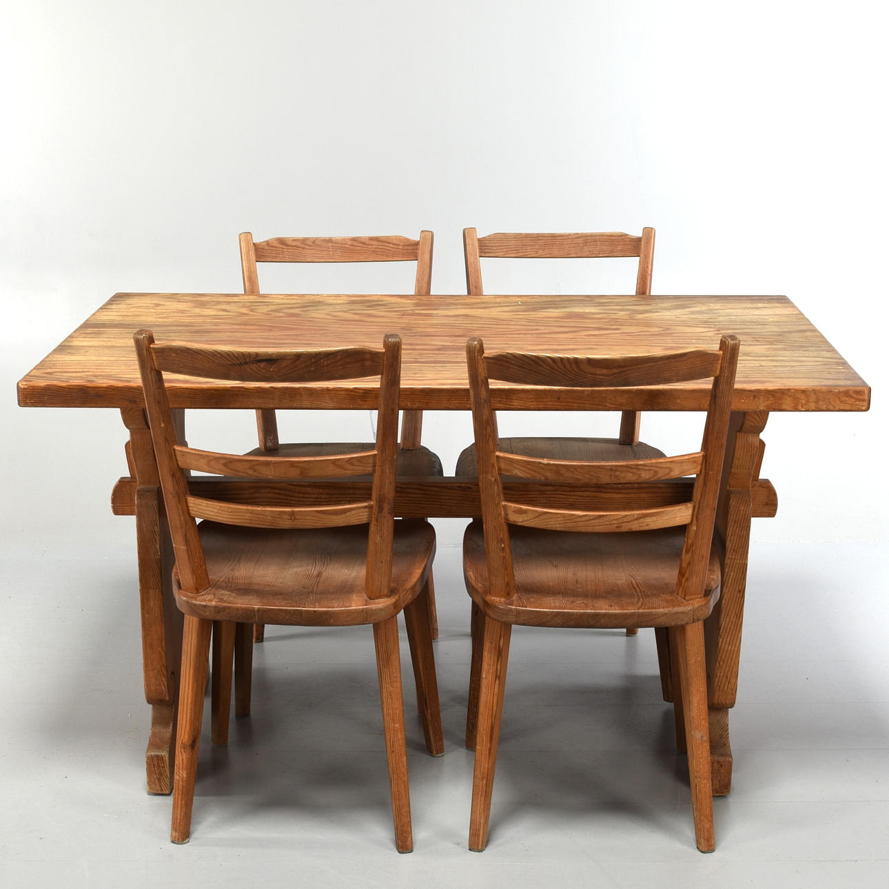 A 20th-century pine table with chairs.