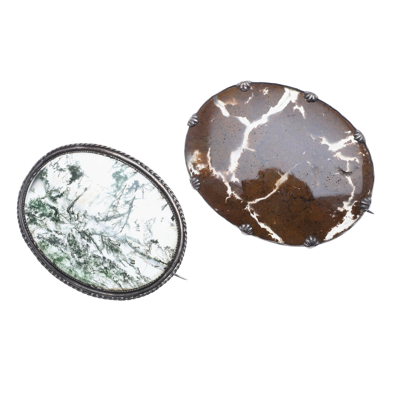 TWO VICTORIAN SILVER MOUNTED STONE PANEL BROOCHES.