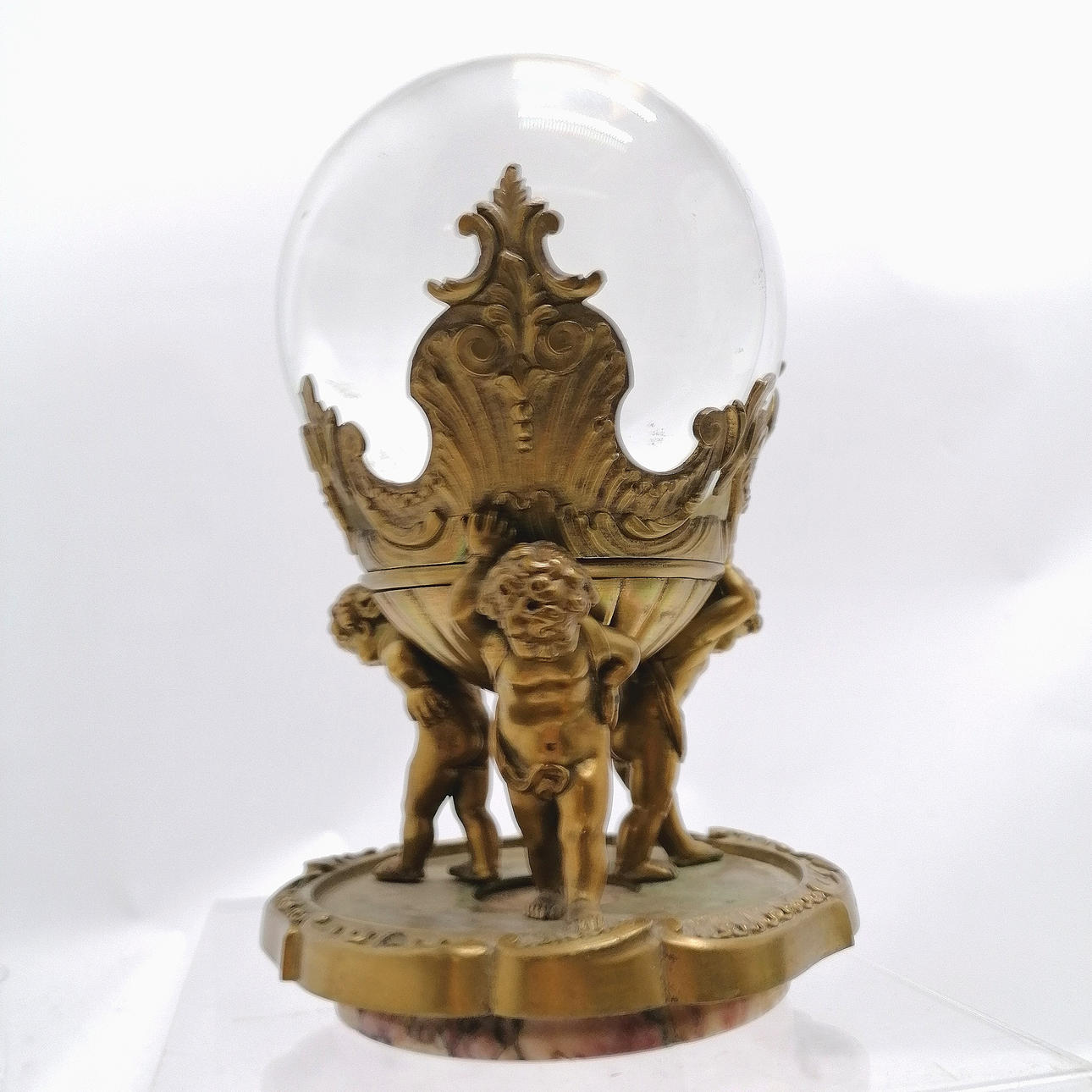 ANTIQUE GLASS SPHERE IN BRASS BASE.