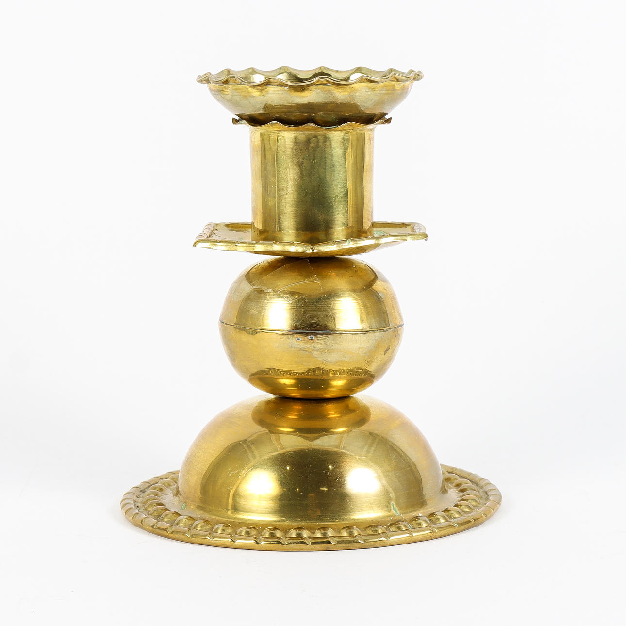 A brass candlestick, 20th century.