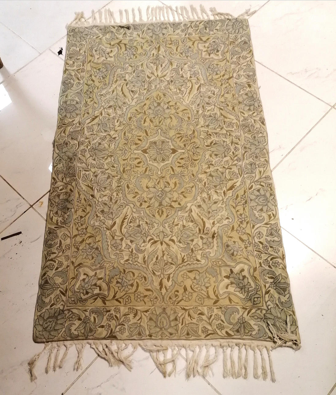 CREWEL WORK CREAM AND BLUE RUG.