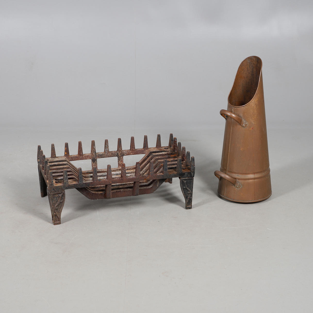 A CAST IRON FIRE GATE AND A COPPER COAL SCUTTLE.