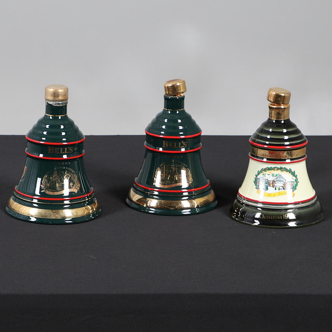 THREE CHRISTMAS COMMEMORATIVE WHISKY BELLS.