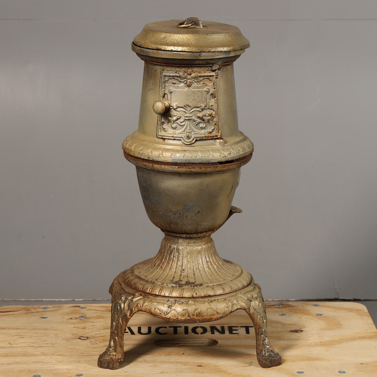 A CAST IRON "POT BELLY" STOVE.