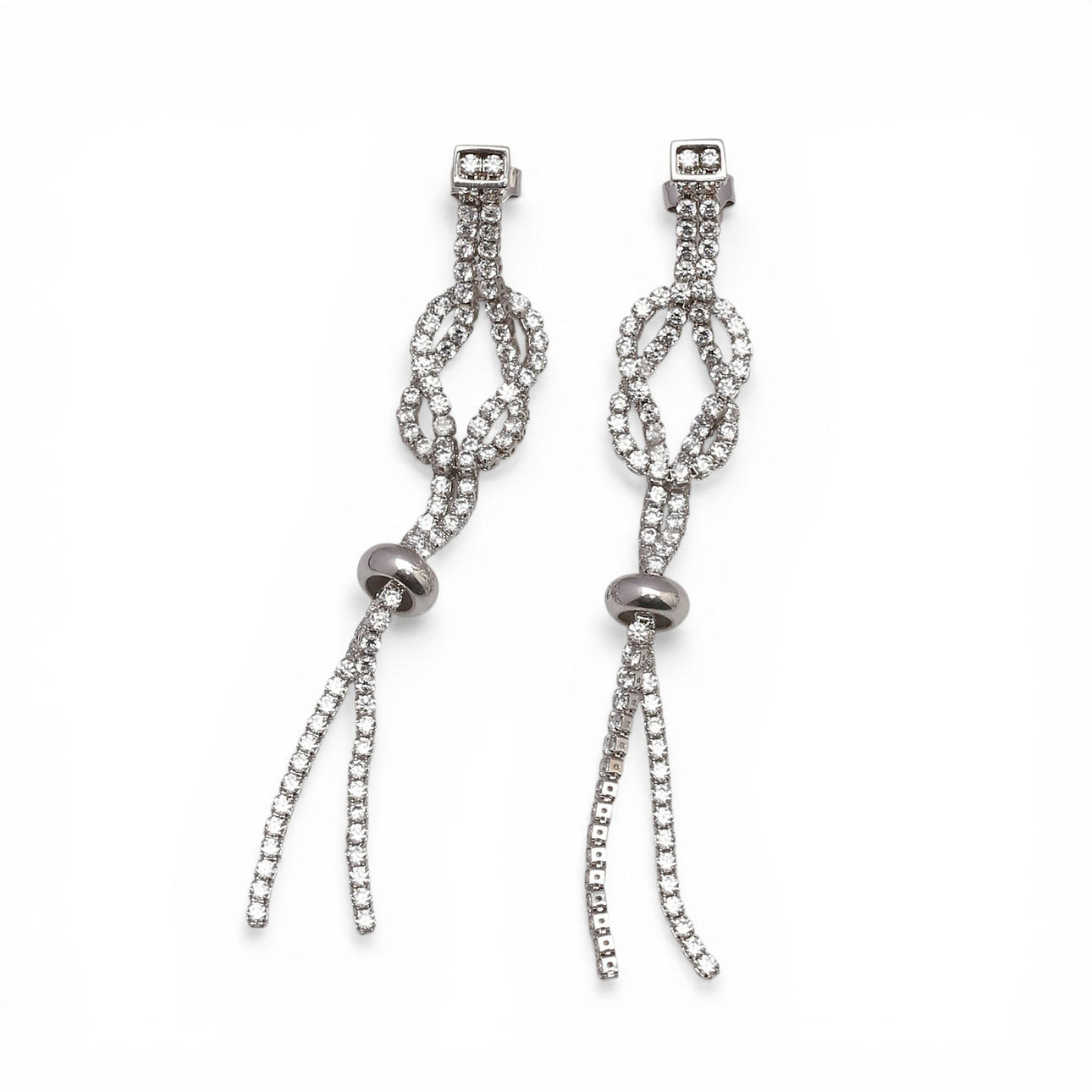 Knot-shaped long earrings in silver and zircons.