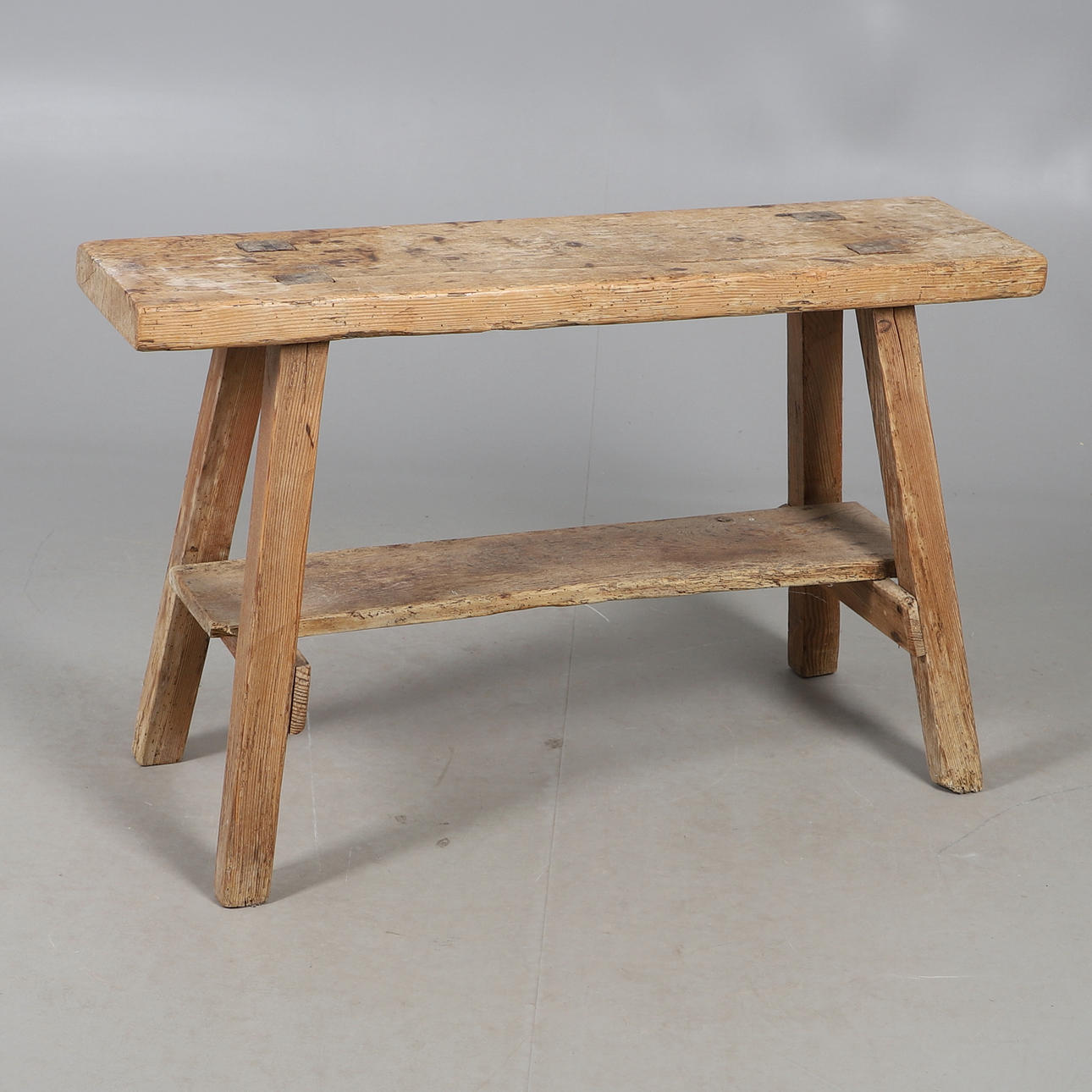 A SMALL WAXED PINE TRESTLE SEAT.