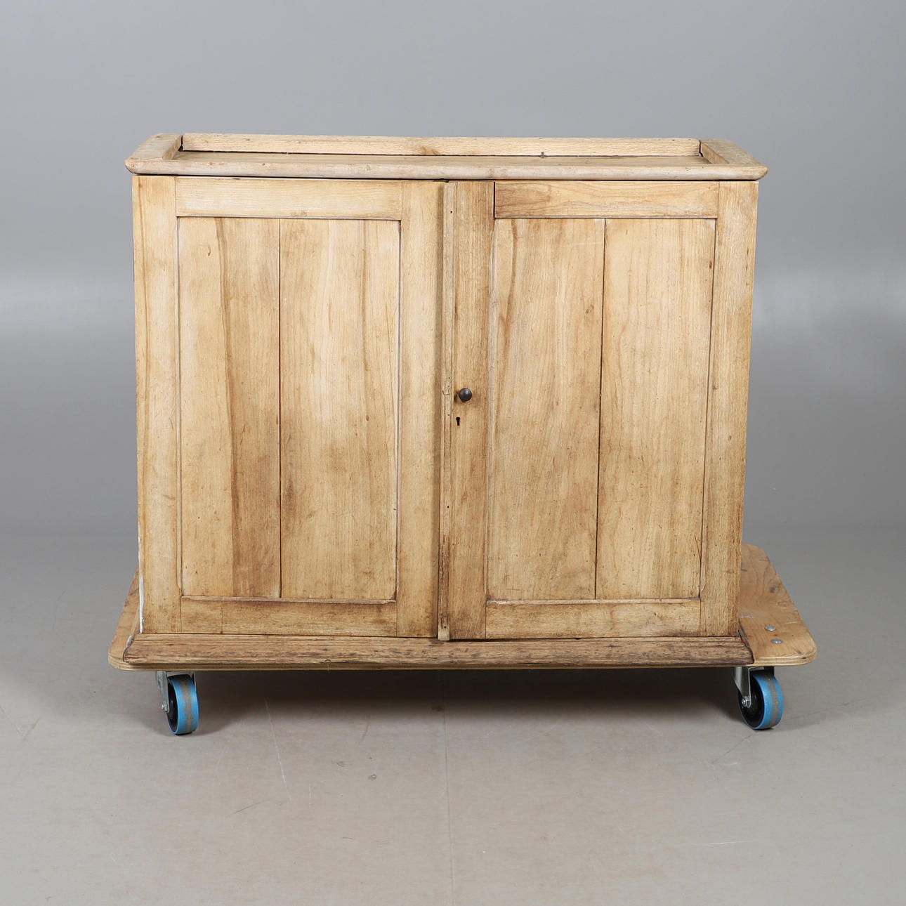 A STRIPPED AND WAXED PINE TWO DOOR CUPBOARD.