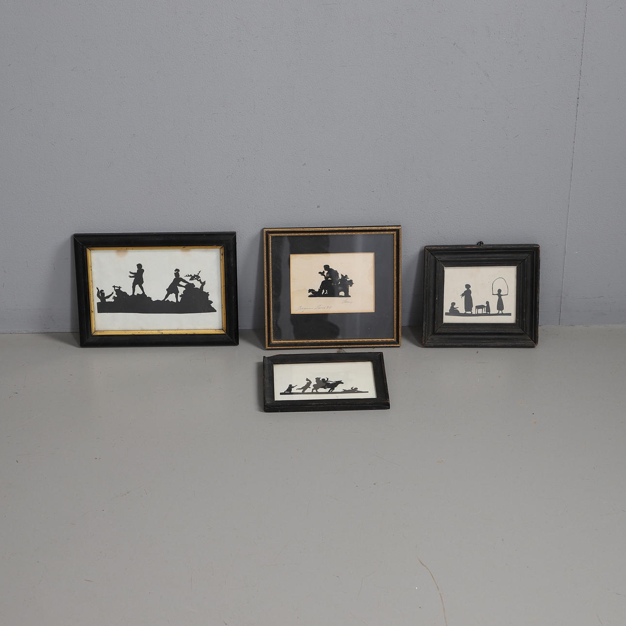 FOUR FRAMED CUT PAPER SILHOUETTES.