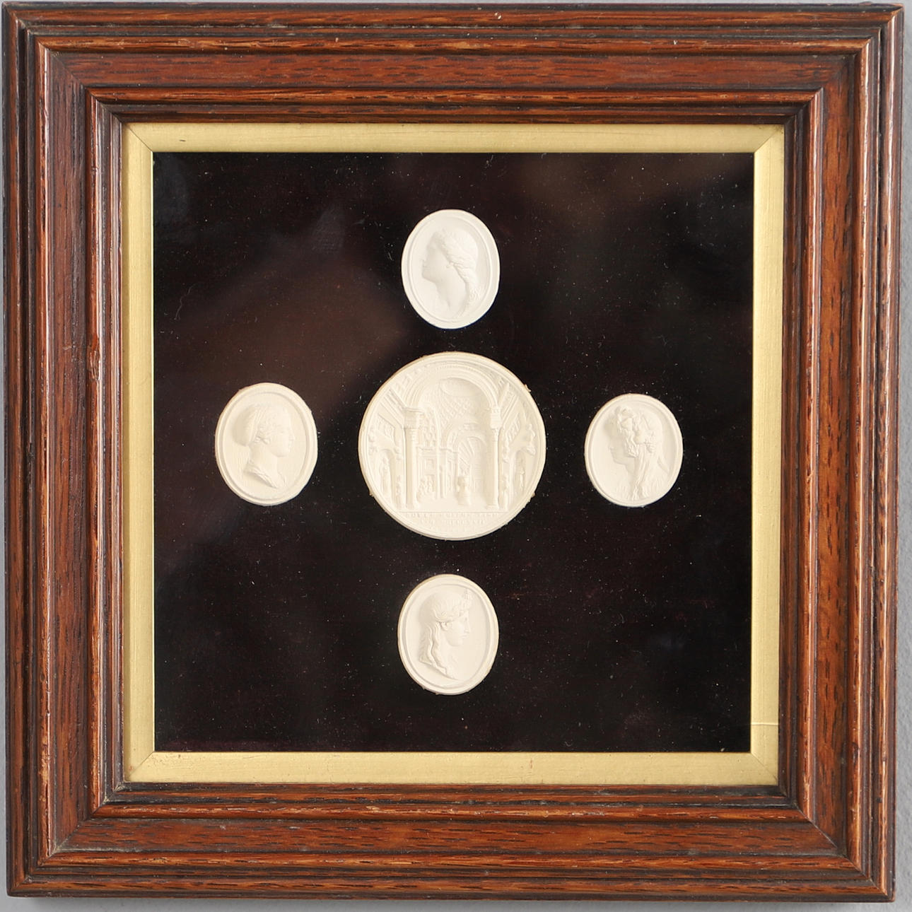 A GROUP OF FRAMED PLASTER CAMEOS.