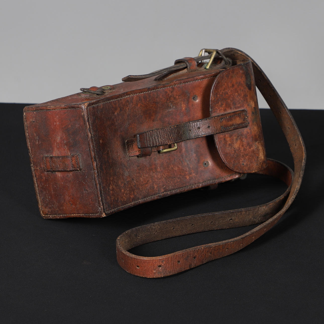 A STITCHED HIDE SHOULDER CASE.