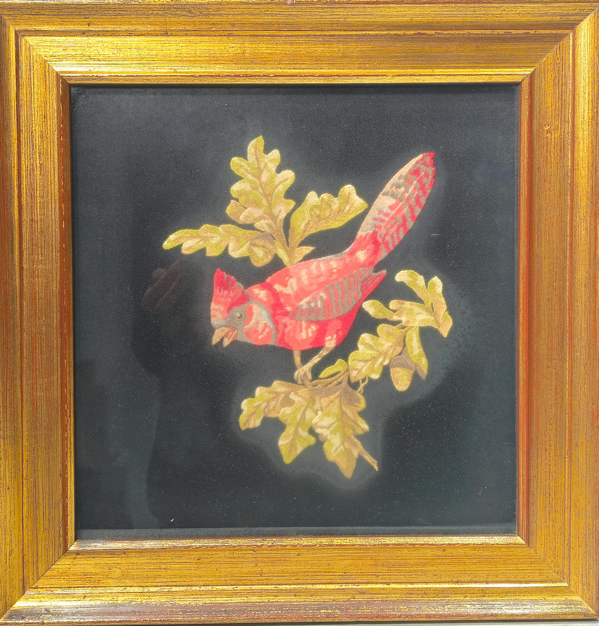 Bird figure embroidered with silk thread and framed.