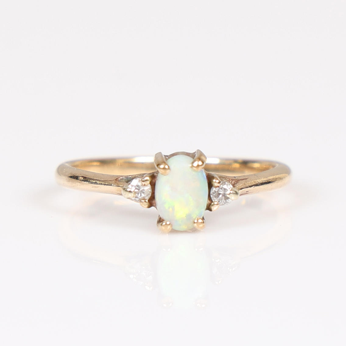 A 9 CARAT GOLD OPAL AND DIAMOND SET RING.