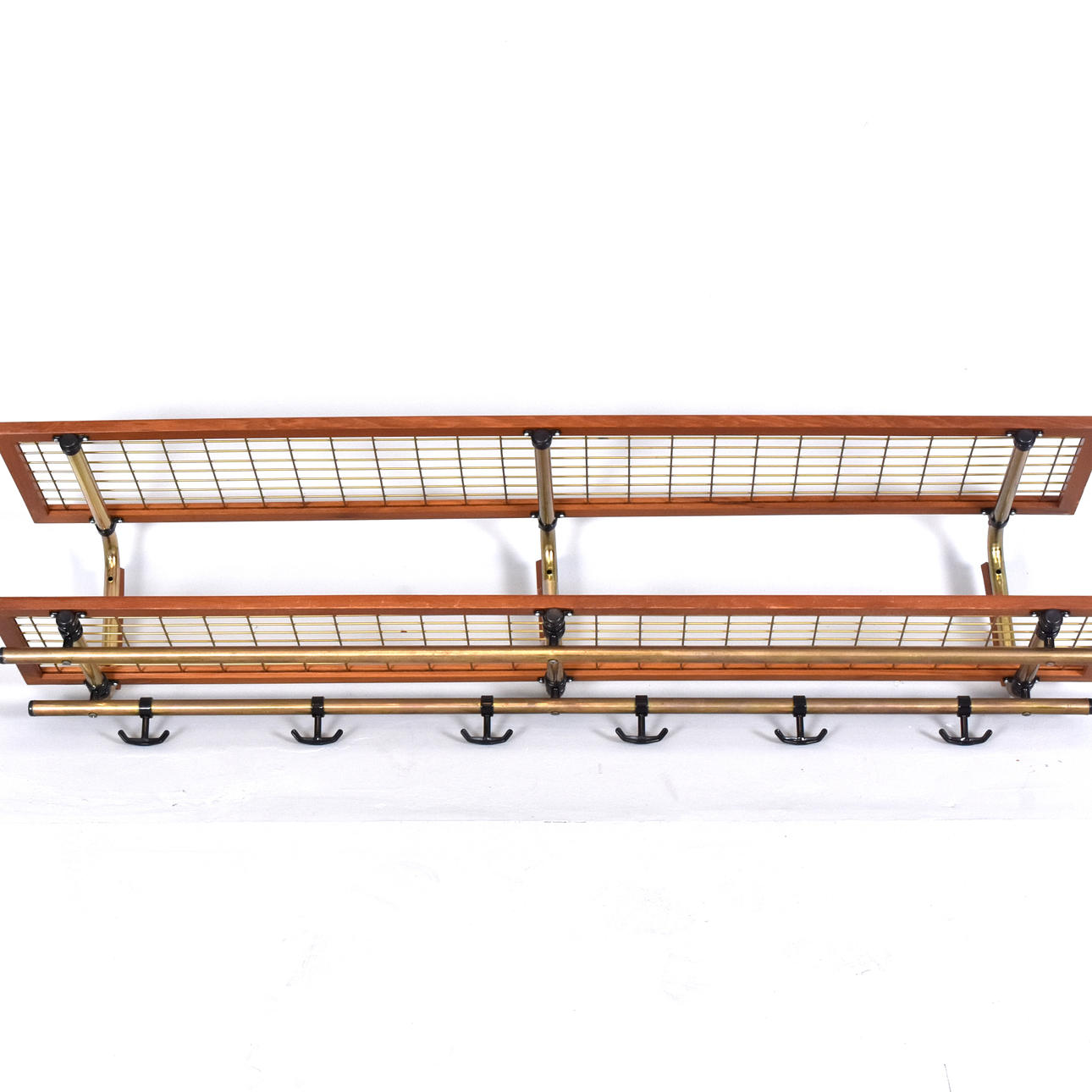 A 1970s teak hat shelf, brass.