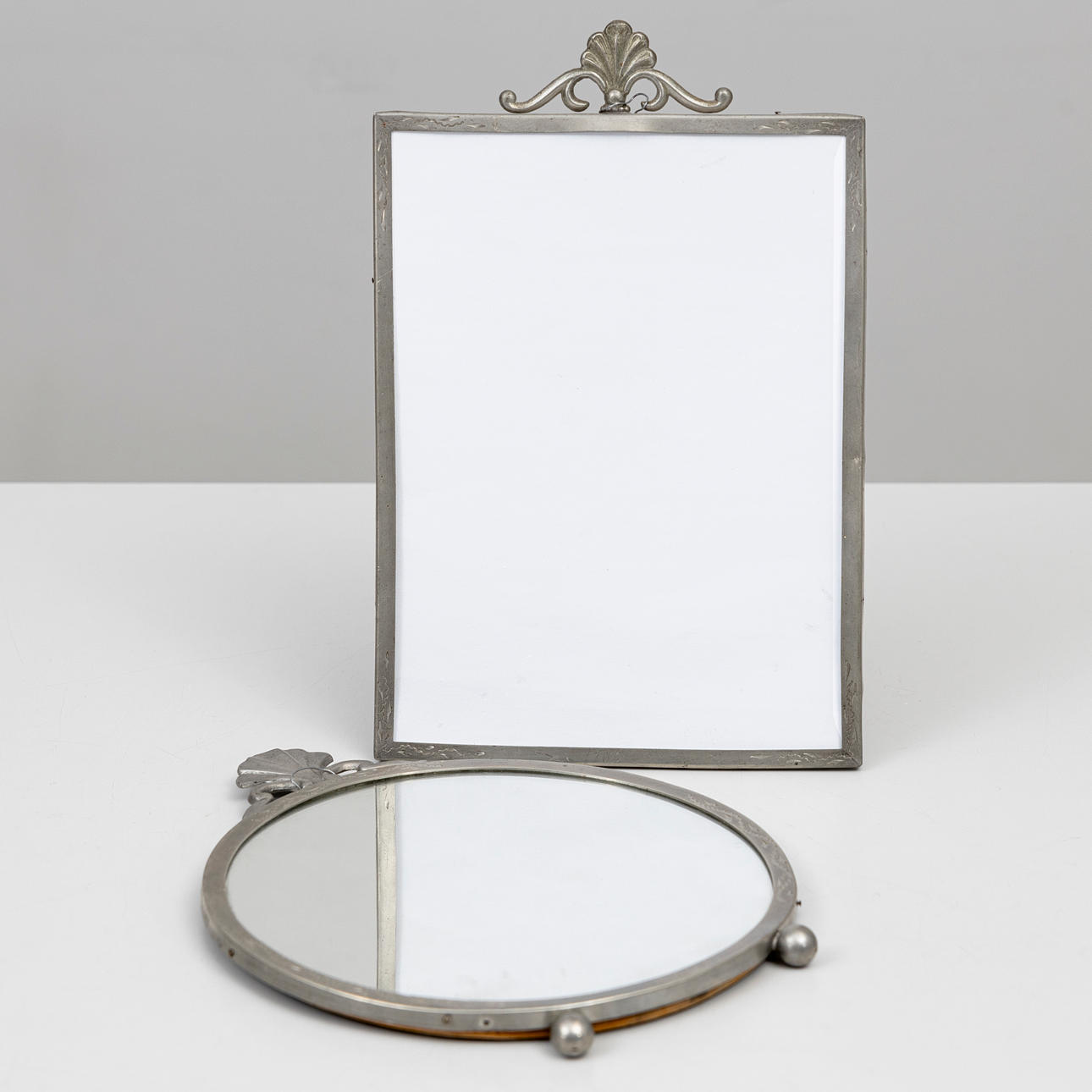 A 1920's pewter table mirror and frame.