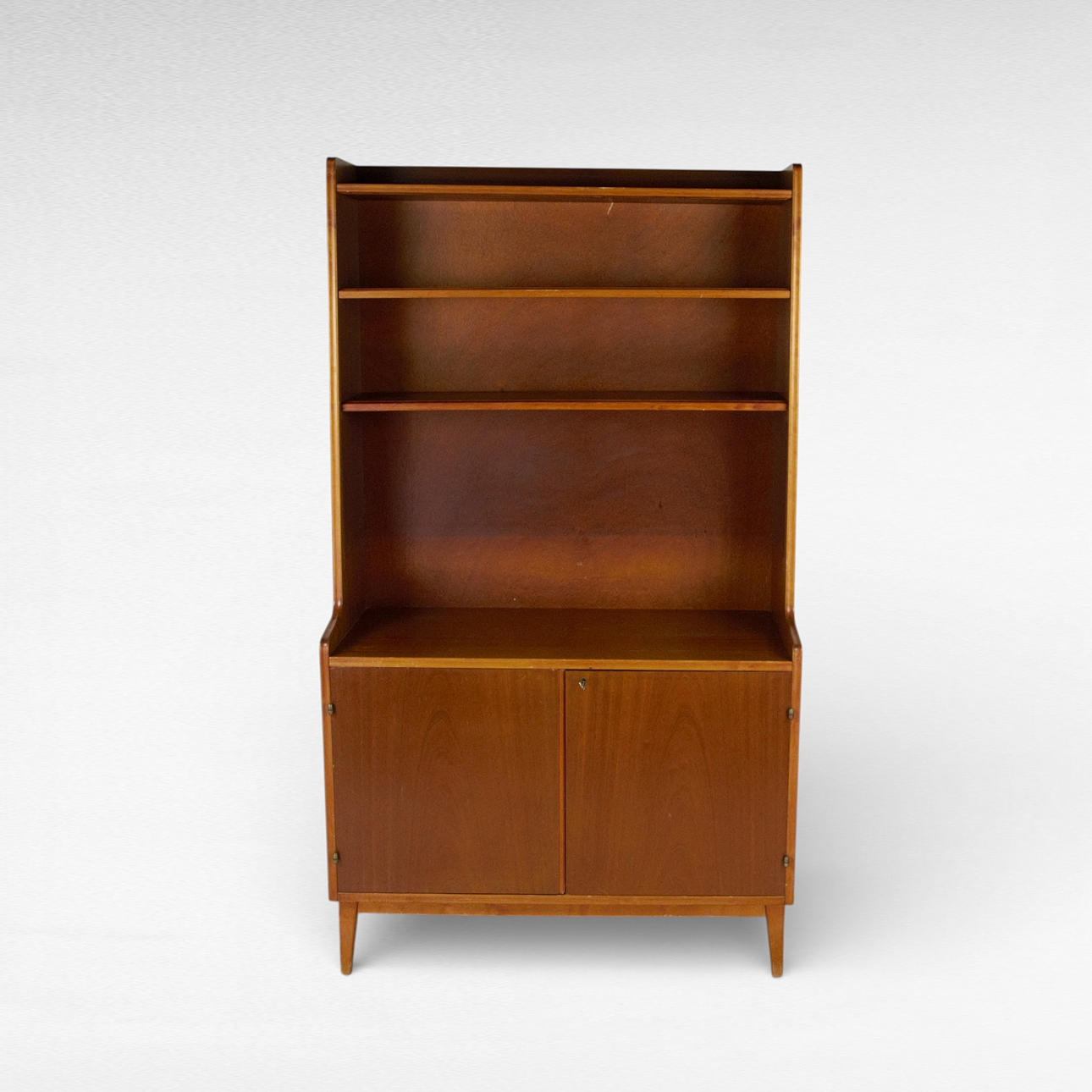 A 1960s mahogany veneer bookcase.