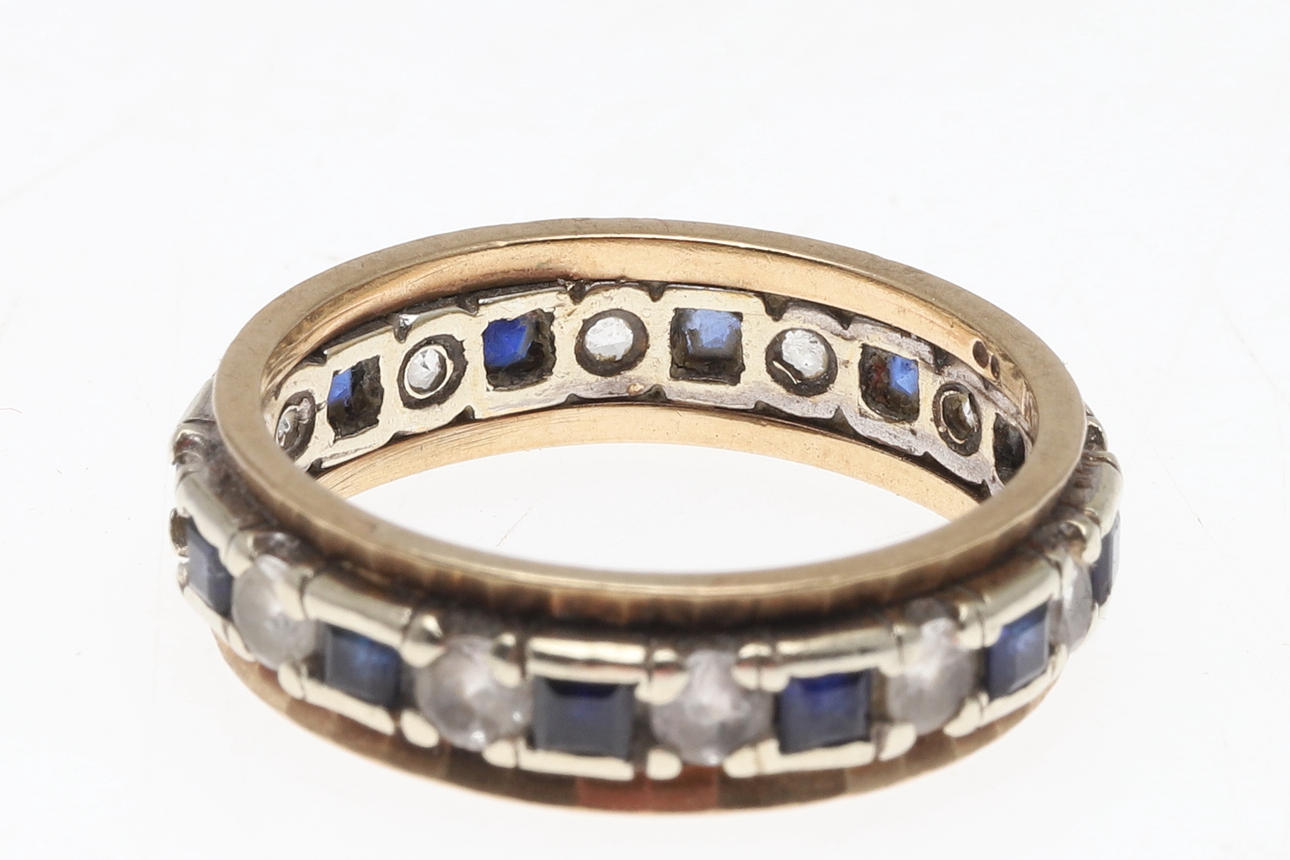A 9CT GOLD AND BLUE AND WHITE STONE ETERNITY RING. Jewellery ...