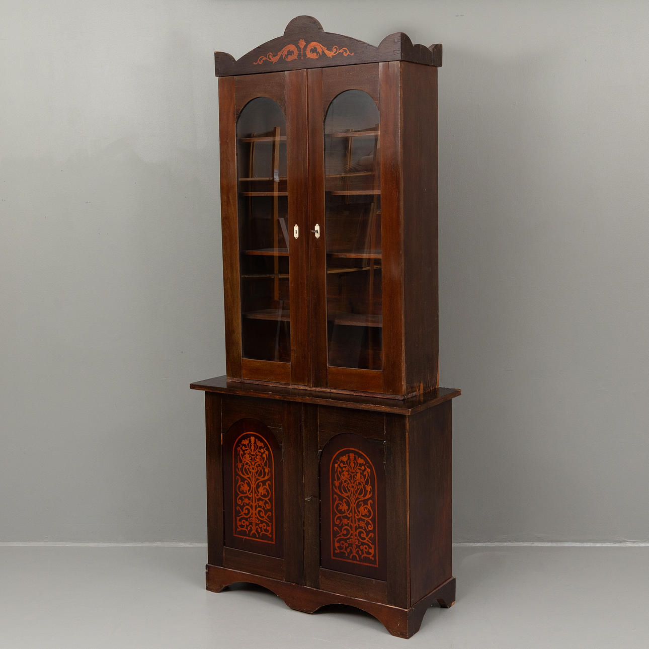 An intarsia bookcase, 19th century.