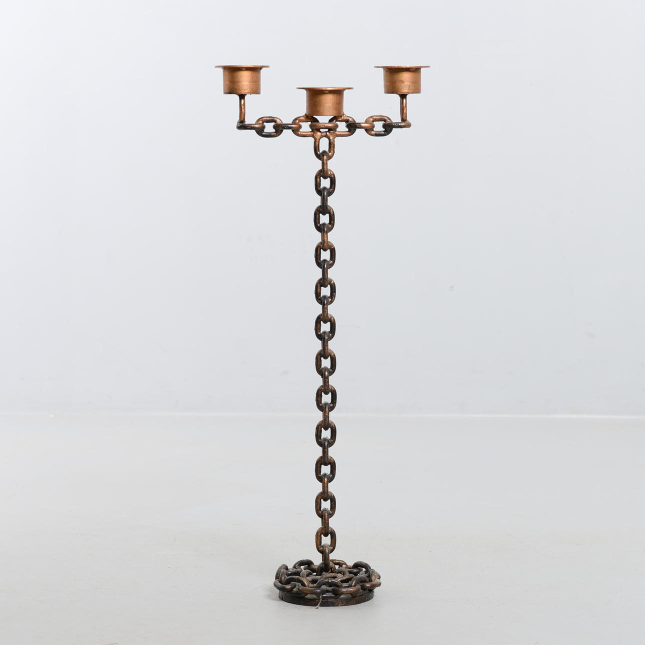 An iron floor candlestick, 20th century.