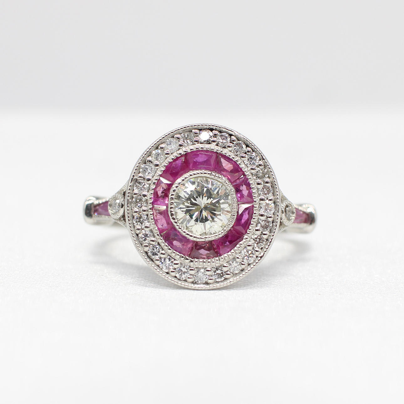 DIAMOND & RUBY TARGET RING IN PLATINUM.