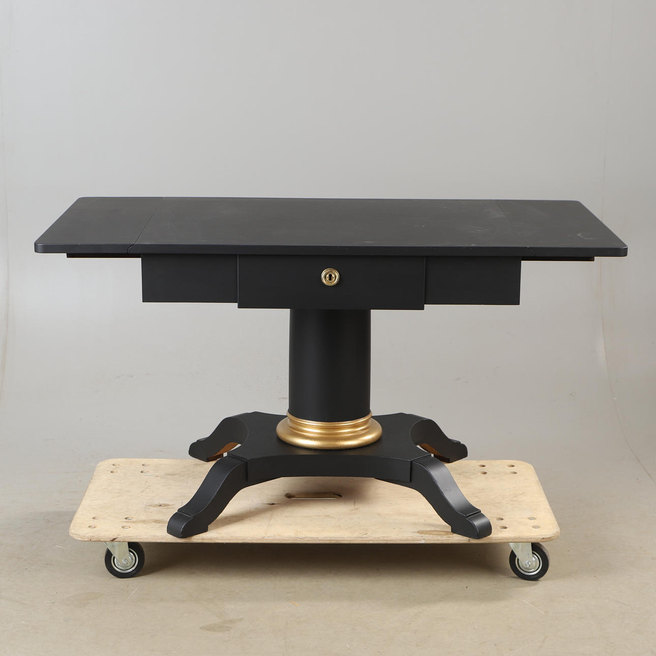 A folding table, painted black, mid 20th century.