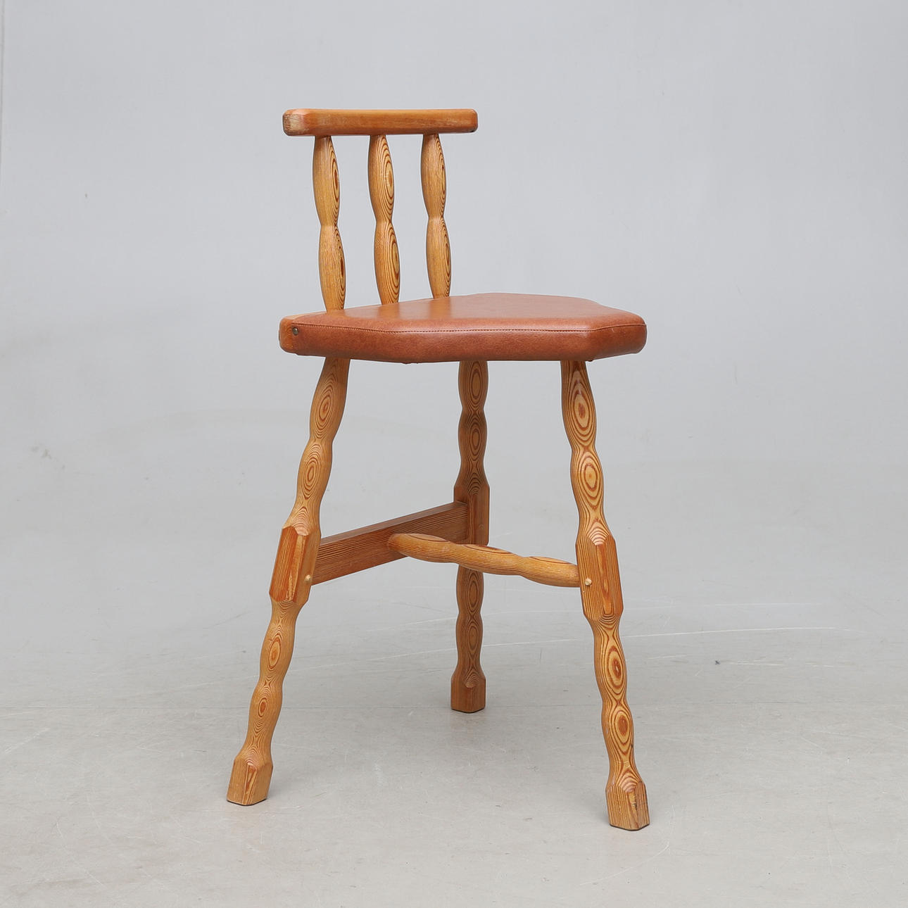 A pine chair, three legs, 20th century.