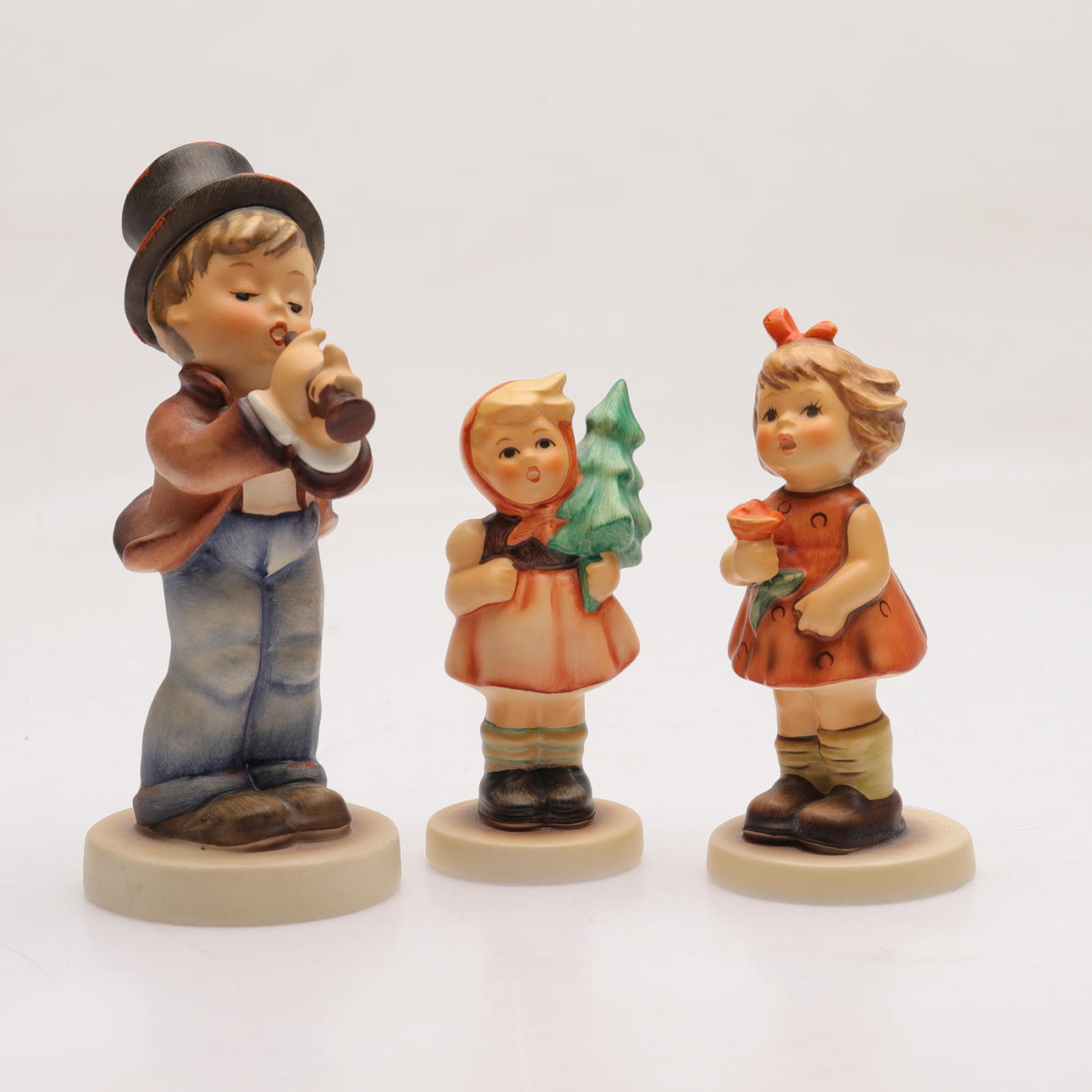 Three porcelain figurines, Hummel, Goebel, Germany.