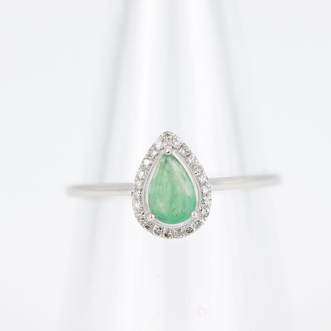 9CT EMERALD AND DIAMOND RING.