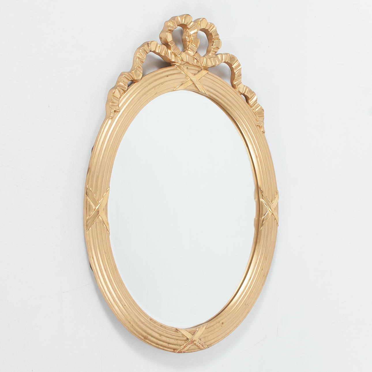 A Gustavian style mirror, oval, gilded frame.